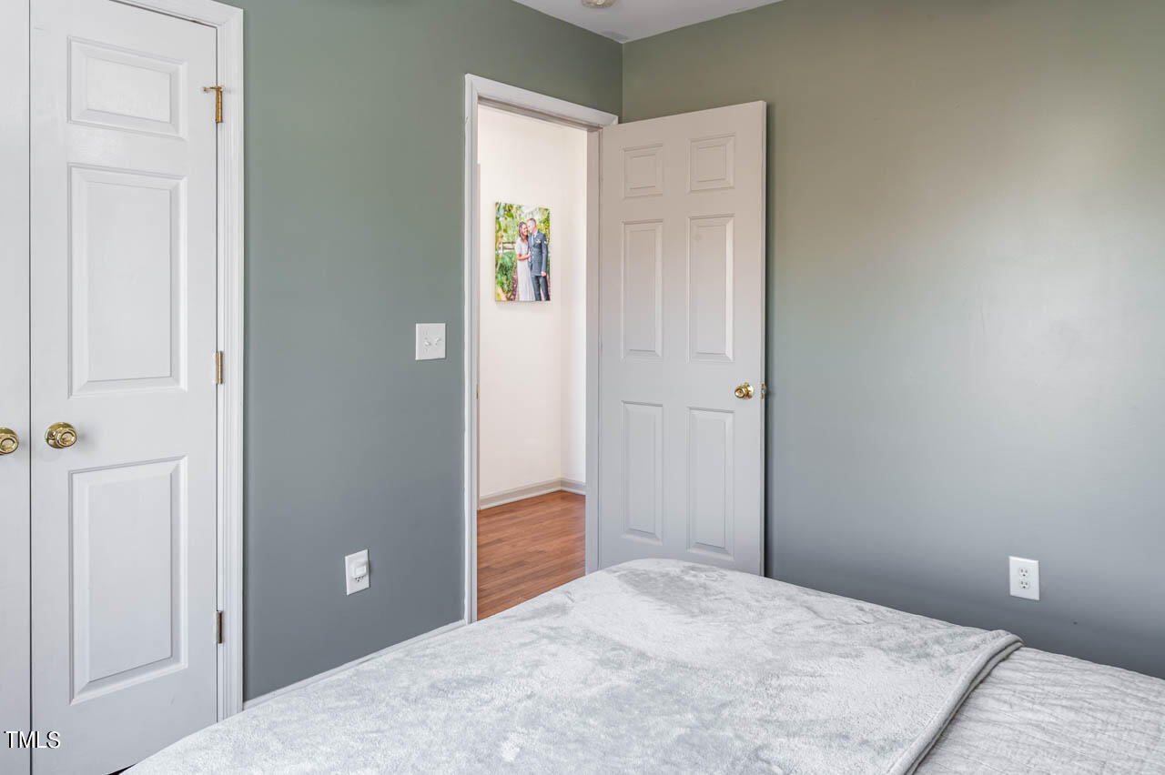 4552 Springbrook Drive Burlington, NC 27215 - Photo 27 of 57 a bedroom with a bed and a table
