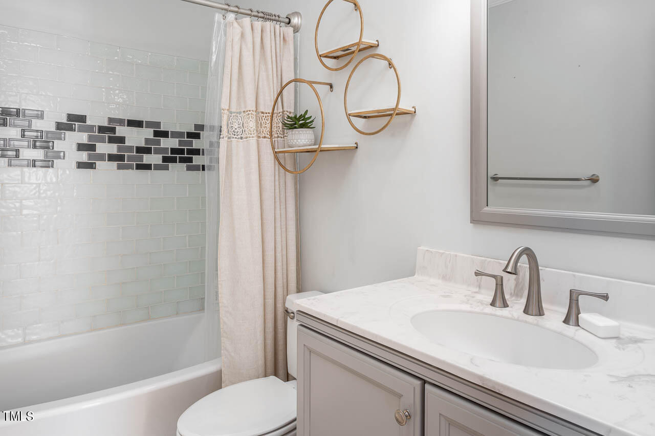 4552 Springbrook Drive Burlington, NC 27215 - Photo 28 of 57 a bathroom with a sink a toilet and shower