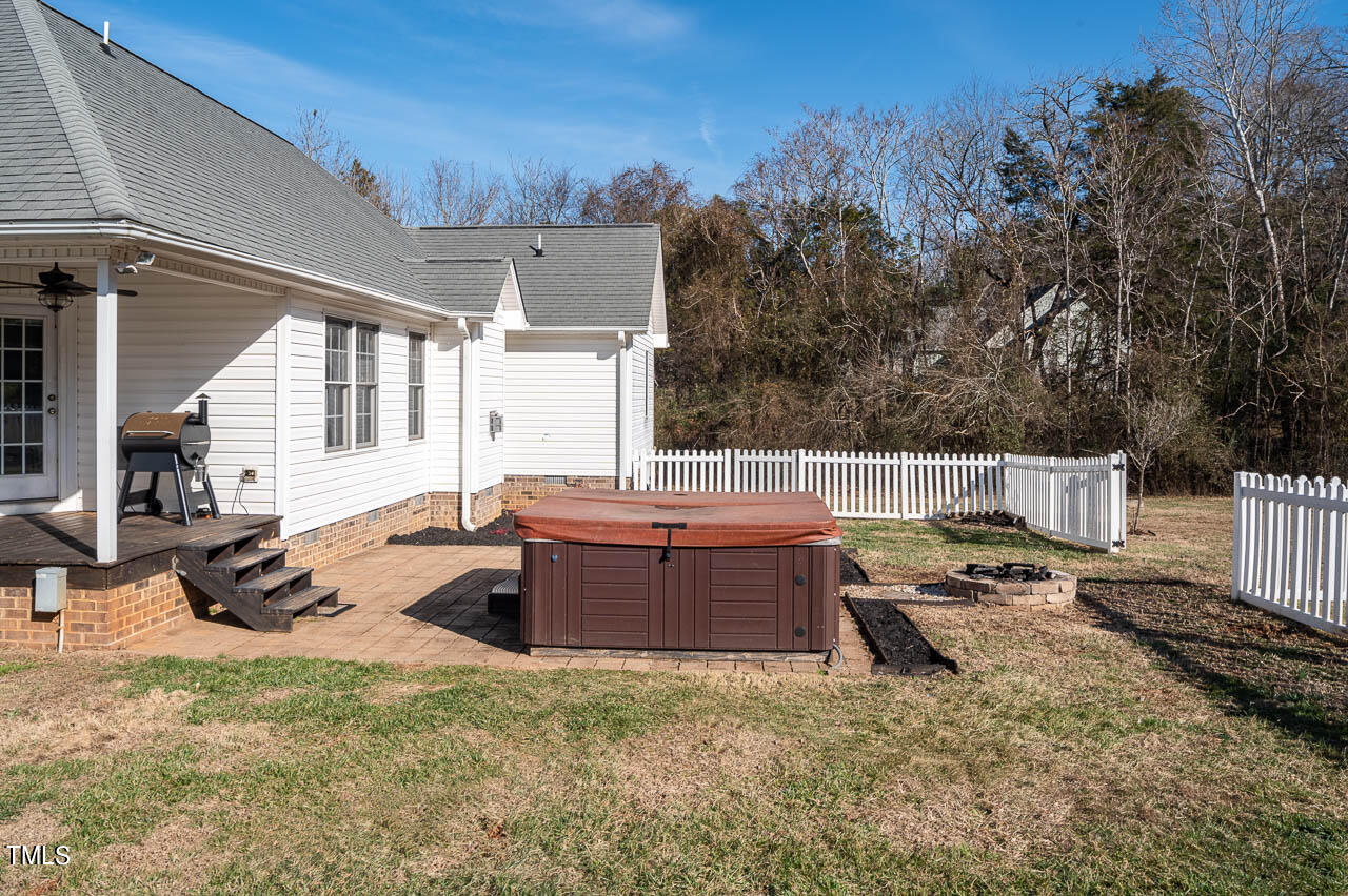 4552 Springbrook Drive Burlington, NC 27215 - Photo 36 of 57 a backyard of a house with table and chairs