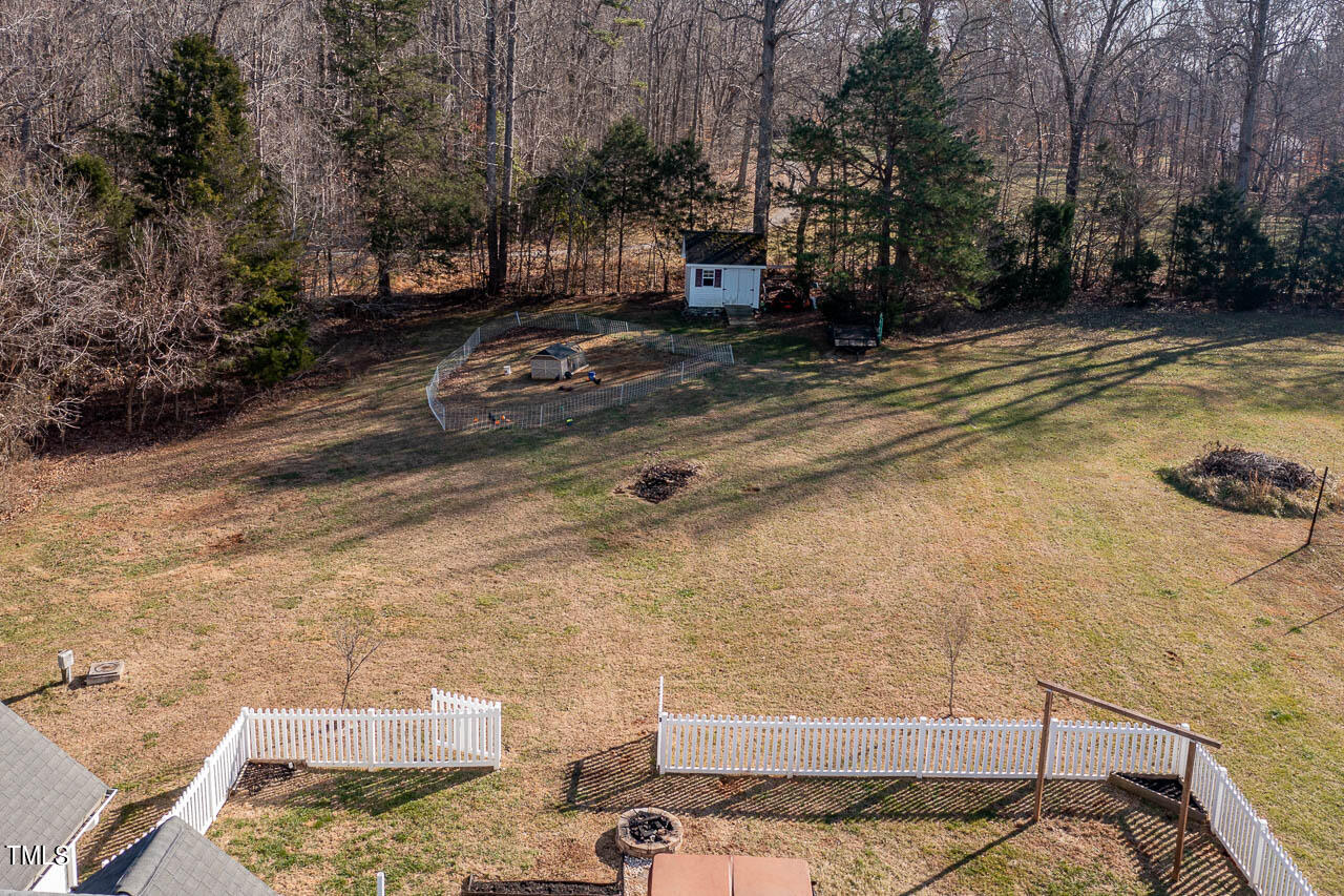 4552 Springbrook Drive Burlington, NC 27215 - Photo 46 of 57 a view of a backyard with plants and trees