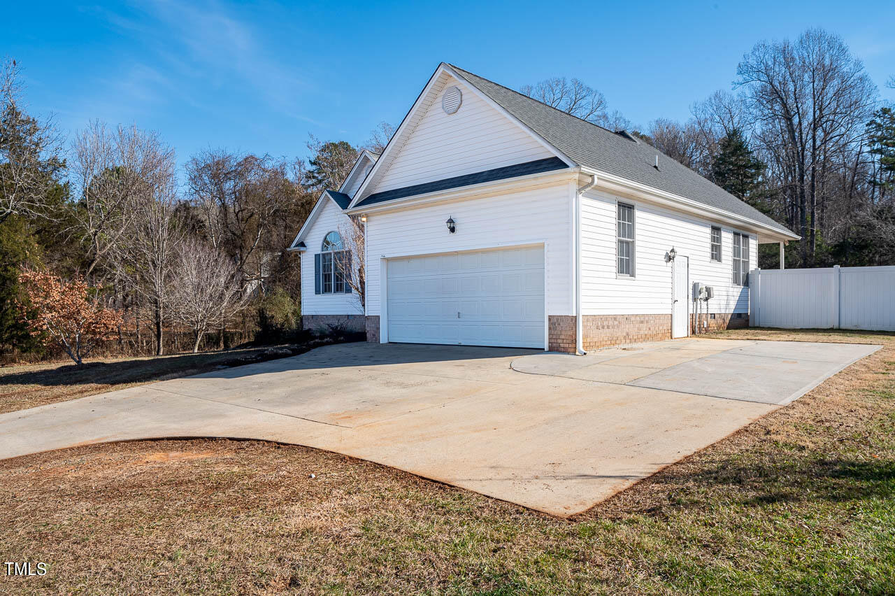 4552 Springbrook Drive Burlington, NC 27215 - Photo 6 of 57 a front view of a house with a yard and garage