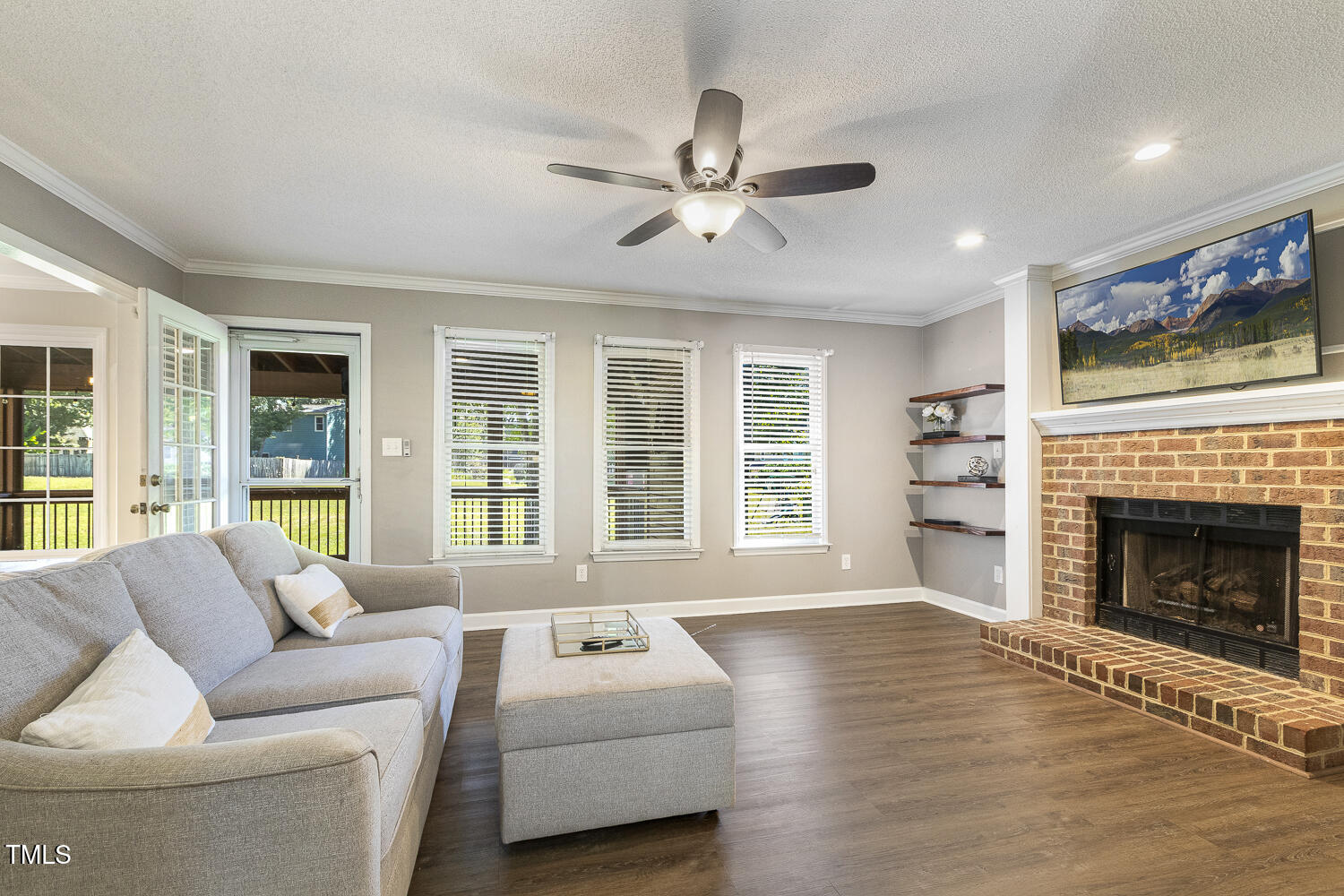 4913 Knightsbridge Way Raleigh, NC 27604 - Photo 6 of 18 Cozy fireplace, built-in shelves, this living room flows right to your screen porch.