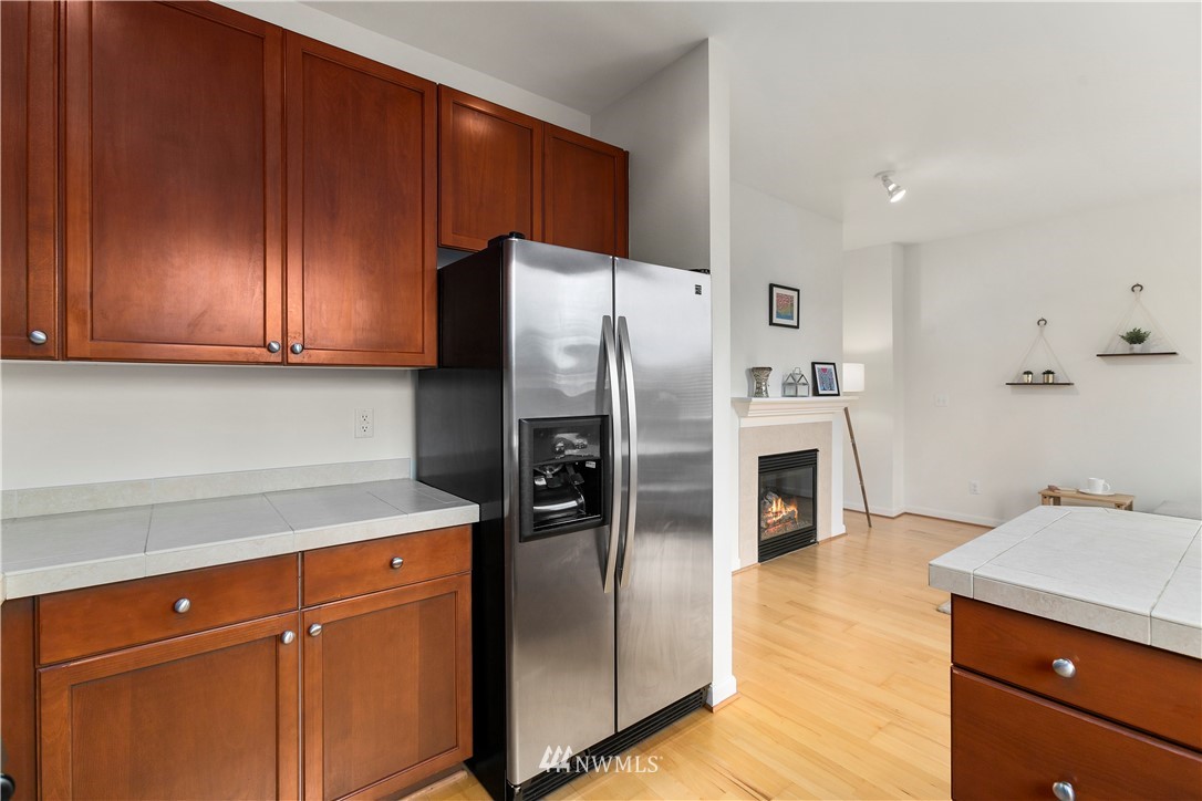 4024 Northeast 4th Place Renton, WA 98056 - Photo 13 of 29 a kitchen with stainless steel appliances granite countertop a refrigerator and a sink