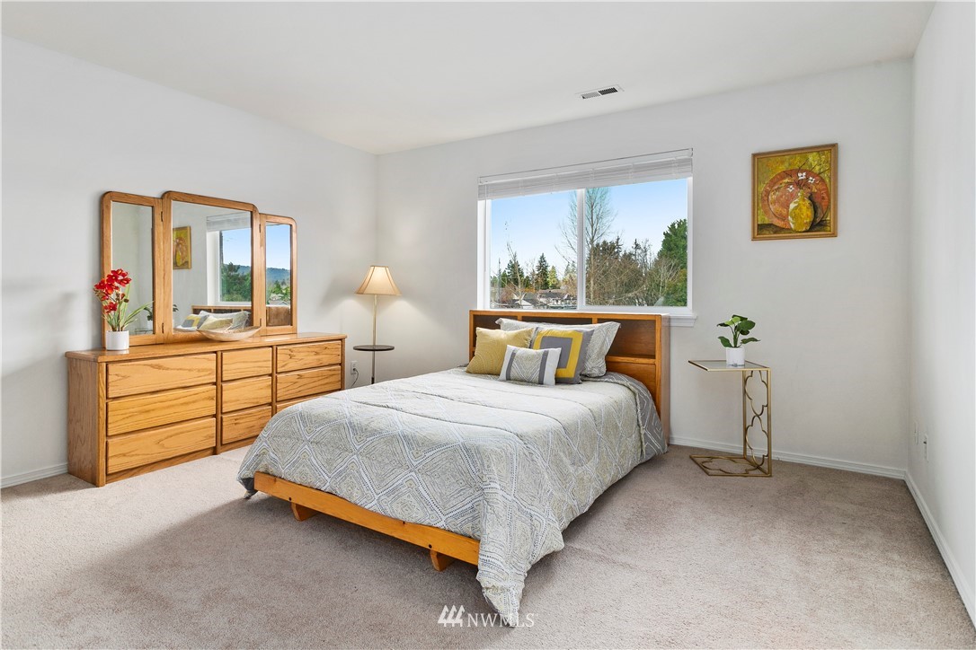 4024 Northeast 4th Place Renton, WA 98056 - Photo 16 of 29 a bedroom with a bed and large windows