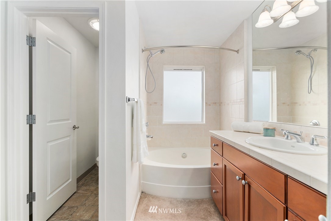 4024 Northeast 4th Place Renton, WA 98056 - Photo 19 of 29 a bathroom with a tub sink and mirror
