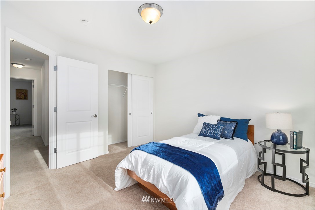 4024 Northeast 4th Place Renton, WA 98056 - Photo 23 of 29 a bedroom with a bed and a lamp