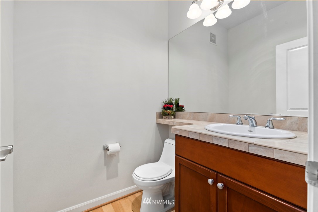 4024 Northeast 4th Place Renton, WA 98056 - Photo 25 of 29 a bathroom with a granite countertop sink mirror and toilet