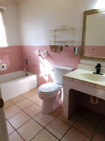 a bathroom with a sink a toilet and a mirror