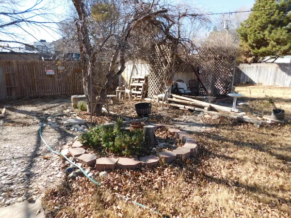 a backyard of a house with a yard and outdoor seating