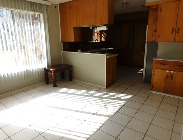 a kitchen with a stove a refrigerator and a sink
