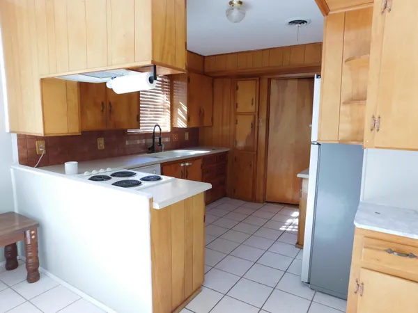 a kitchen with a stove and a refrigerator