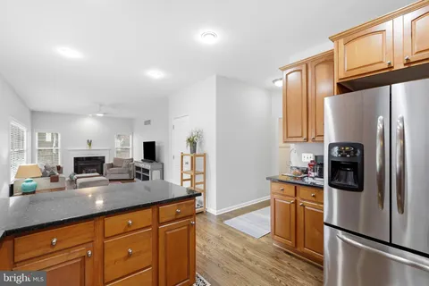 a kitchen with stainless steel appliances granite countertop a refrigerator stove and microwave