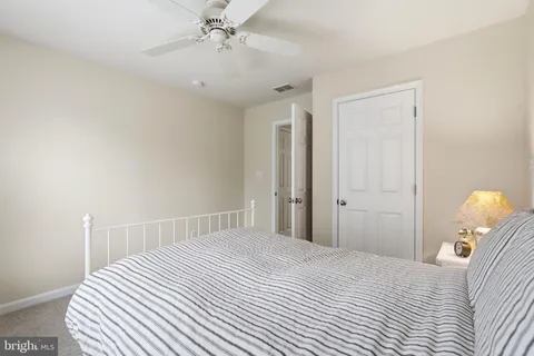 a spacious bedroom with a bed and a chandelier