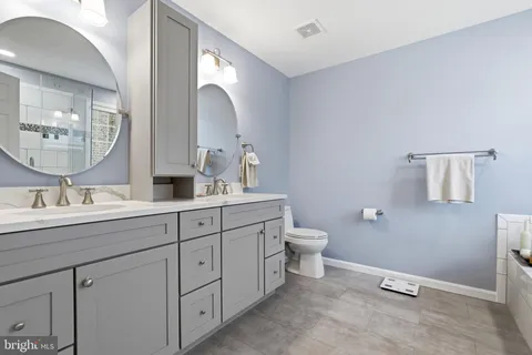 a view of an empty room with closet and a window