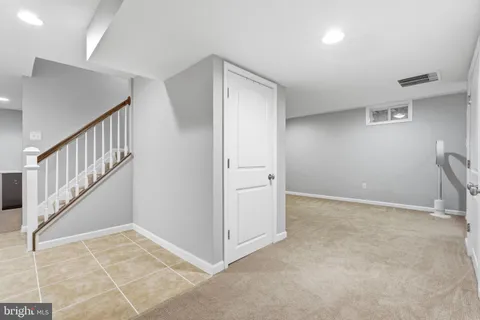 a bedroom with a bed and a view of living room