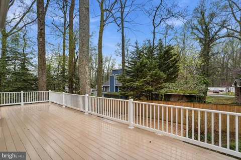 a view of a house with backyard and a tree