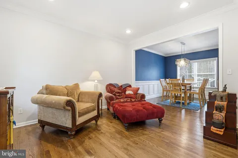a living room with furniture a rug and a window