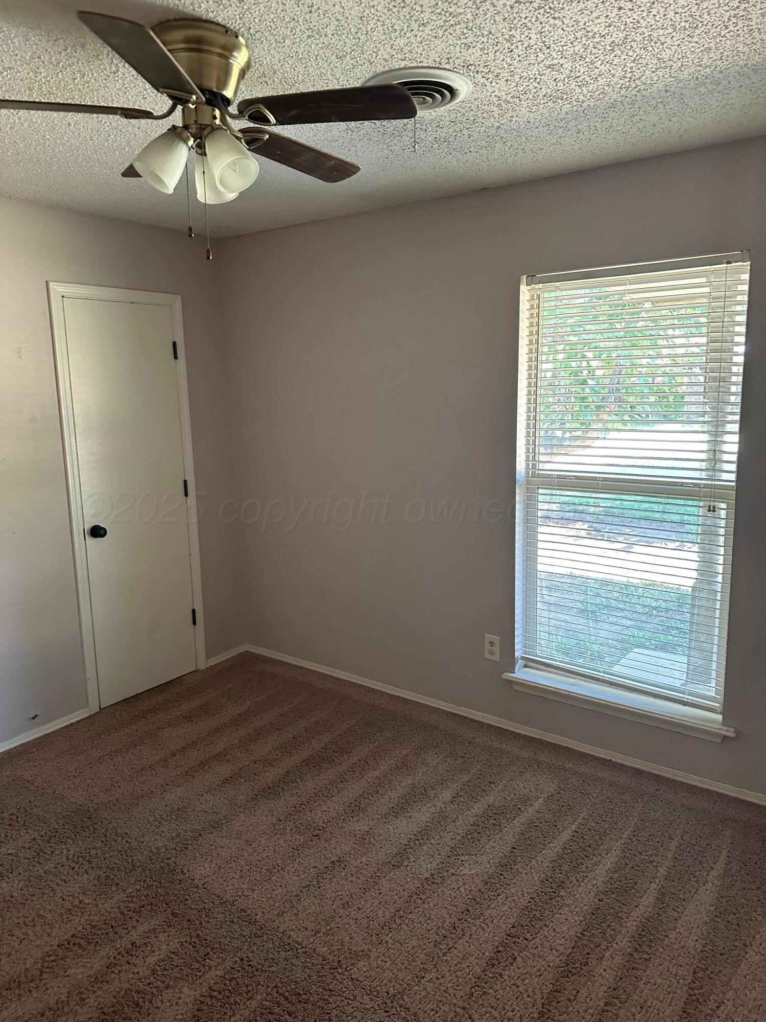 1003 Cimarron Trail Canyon, TX 79015 - Photo 14 of 16 an empty room with a window and a fan