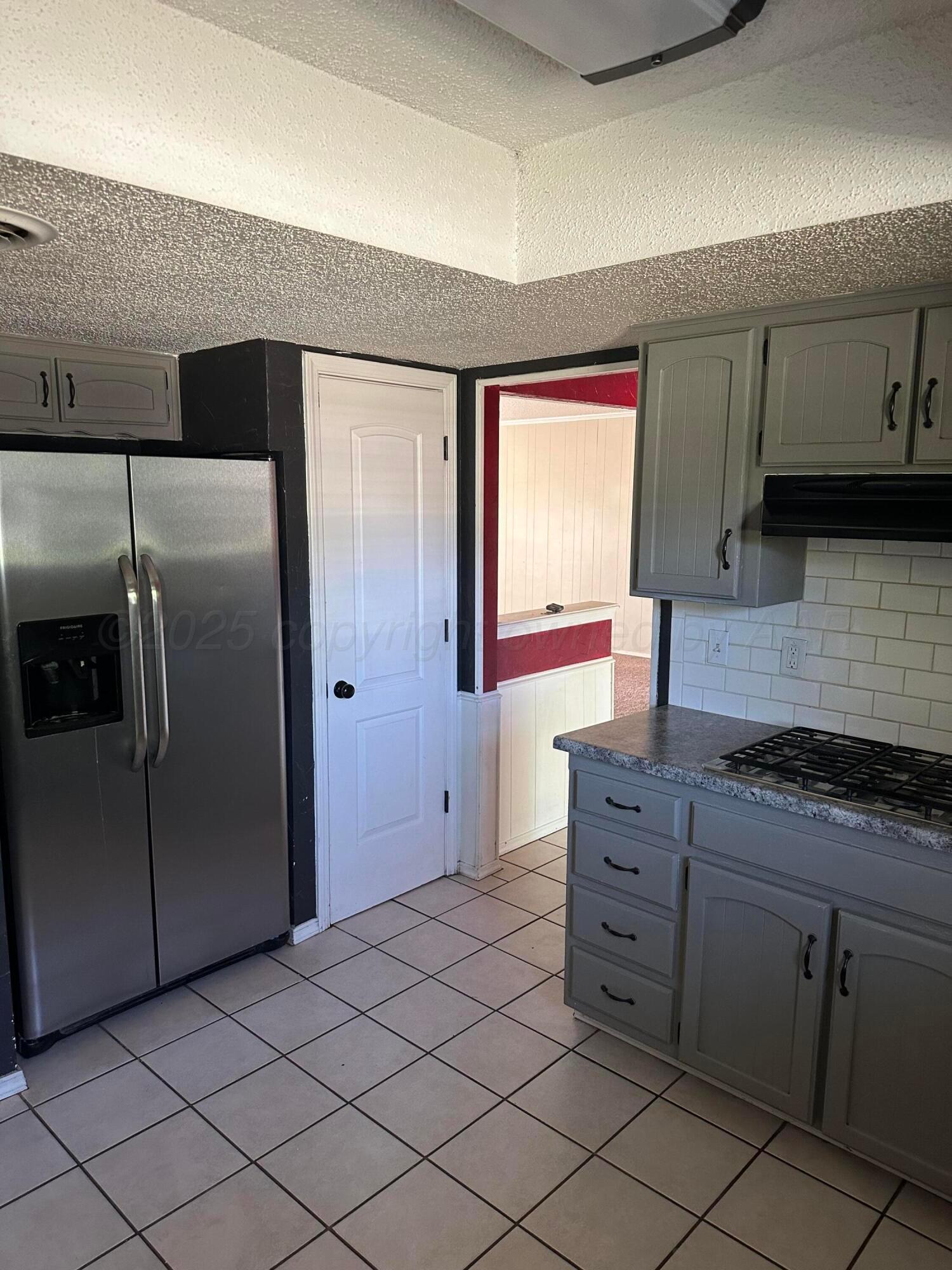 1003 Cimarron Trail Canyon, TX 79015 - Photo 4 of 16 a kitchen with stainless steel appliances granite countertop a refrigerator and a stove