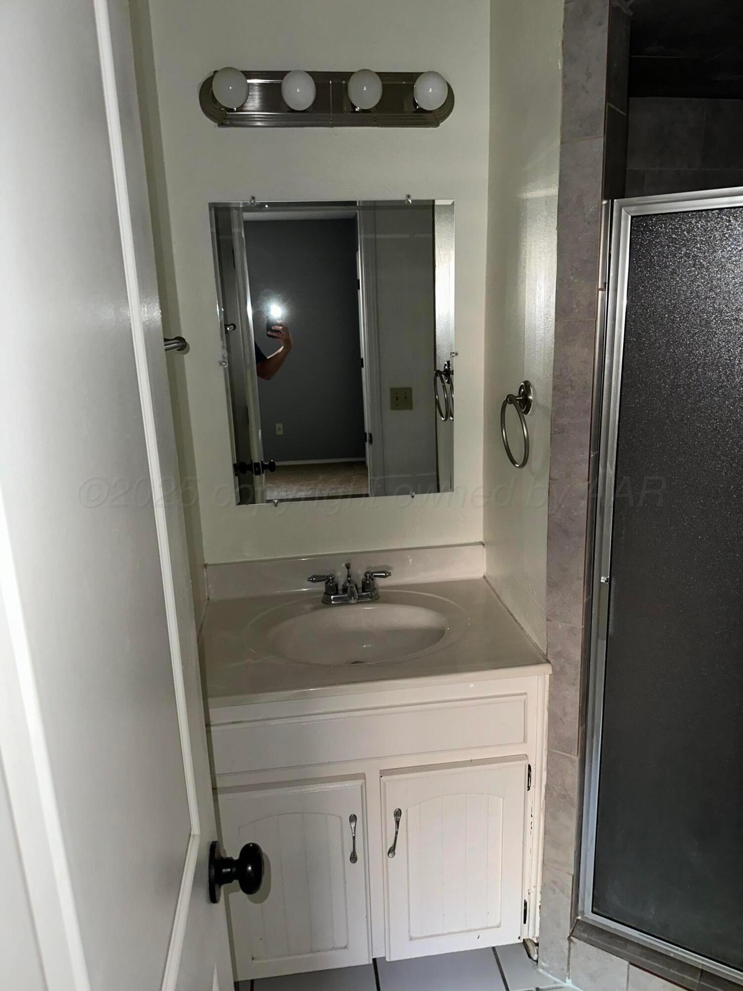 1003 Cimarron Trail Canyon, TX 79015 - Photo 10 of 16 a bathroom with a sink and a mirror