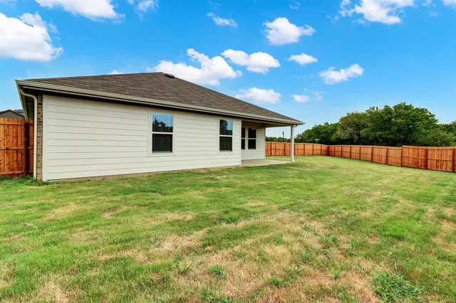 a backyard of a house with lots of green space