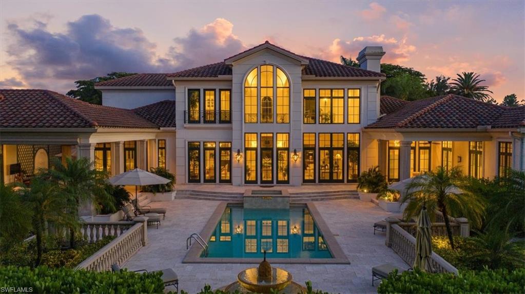 6547 Highcroft Drive Naples, FL 34119 - Photo 3 of 50 a front view of house with a garden and swimming pool