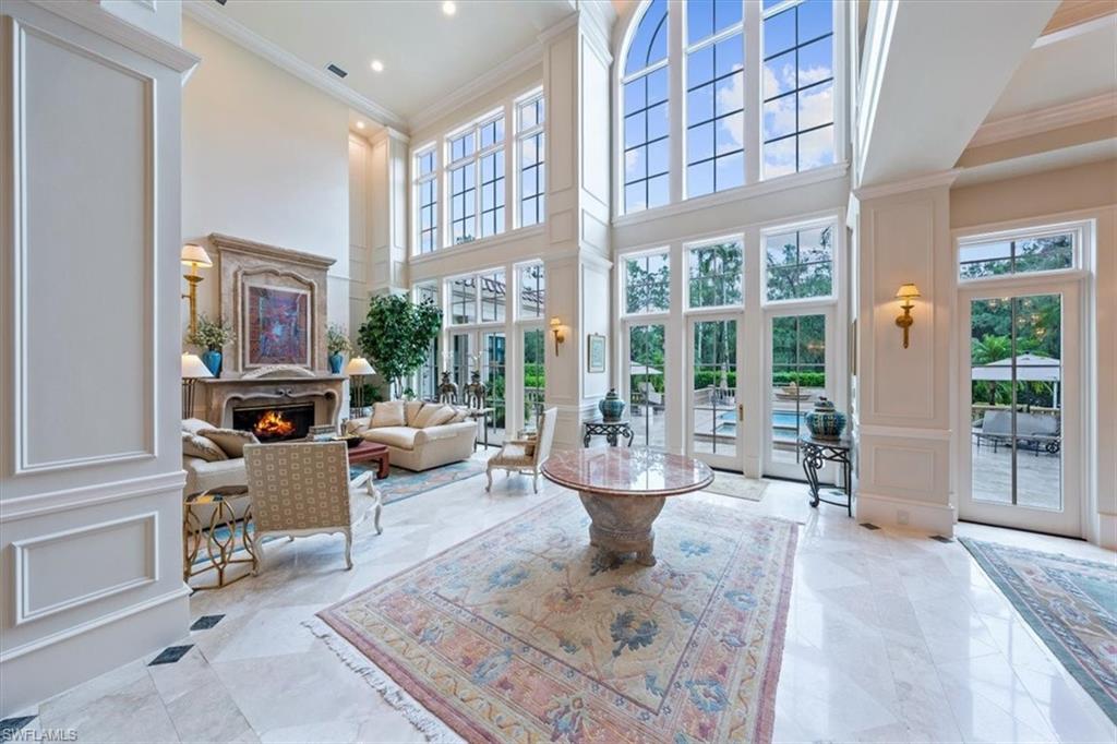 6547 Highcroft Drive Naples, FL 34119 - Photo 8 of 50 a living room with furniture large window and glass door
