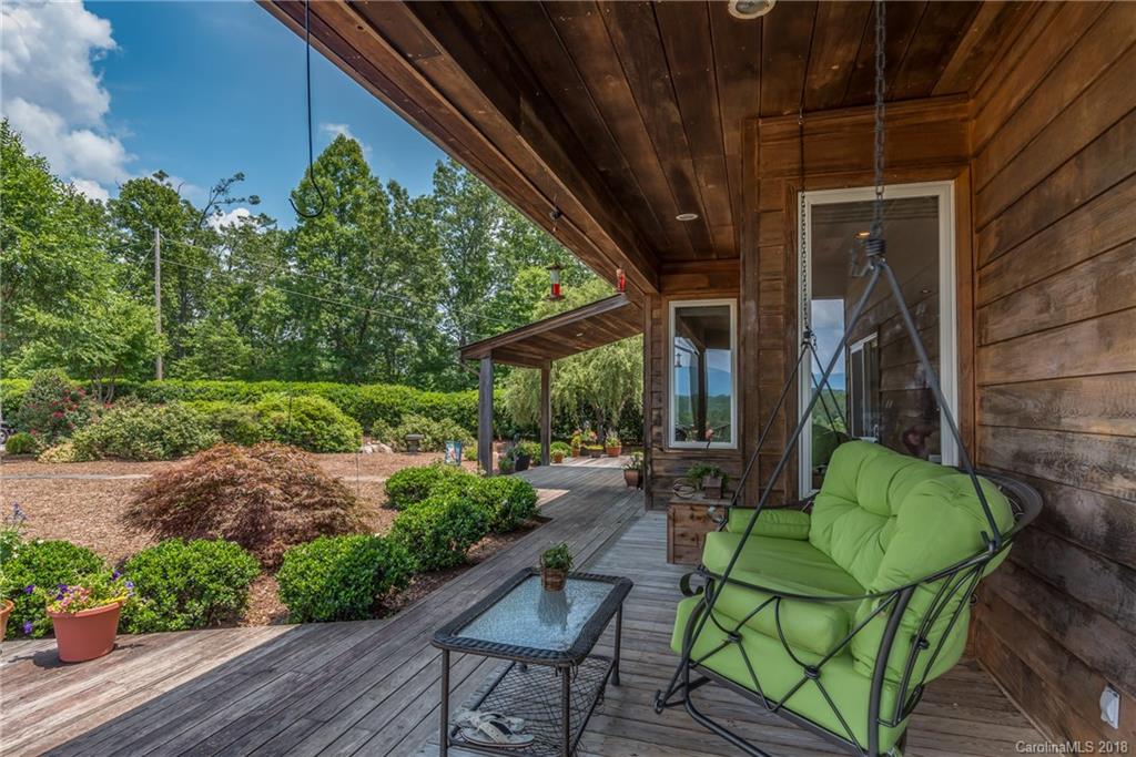 506 Jones Road Mill Spring, NC 28756 - Photo 3 of 32 a view of a chair and table in backyard of the house