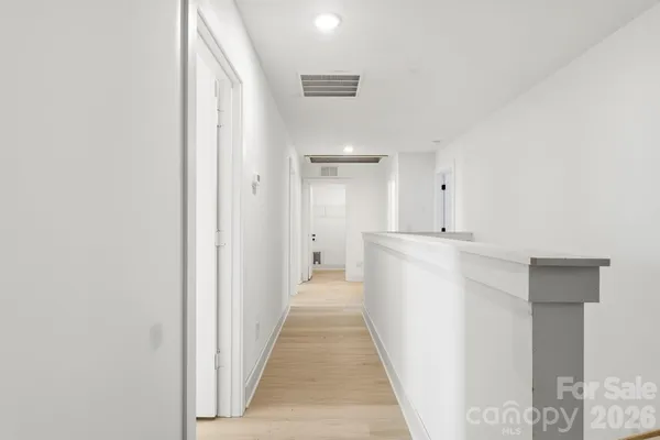 a view of a hallway with a white walls