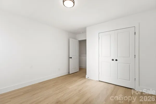 a view of an empty room and wooden floor