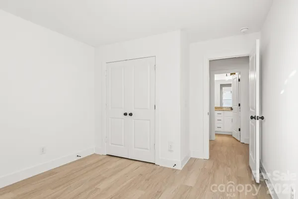 a view of a room with wooden floor