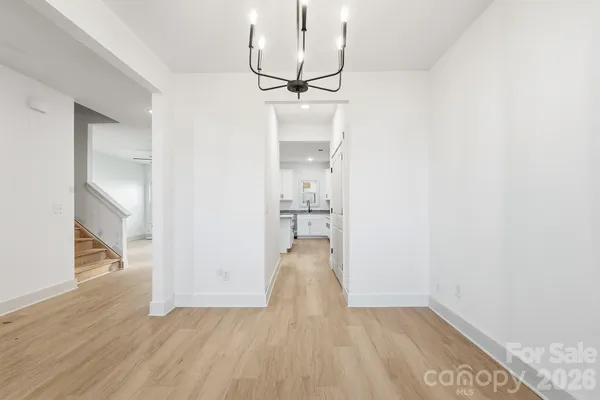 a view of a room with wooden floor and staircase