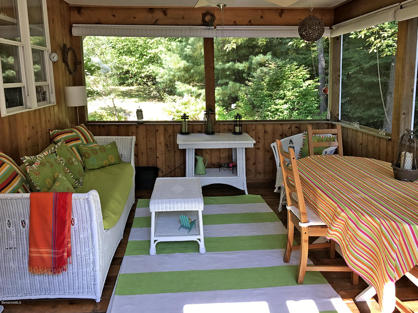 515 Ed Jones Road Otis, MA 01253 - Photo 19 of 21 a balcony view with a dining table and a fireplace