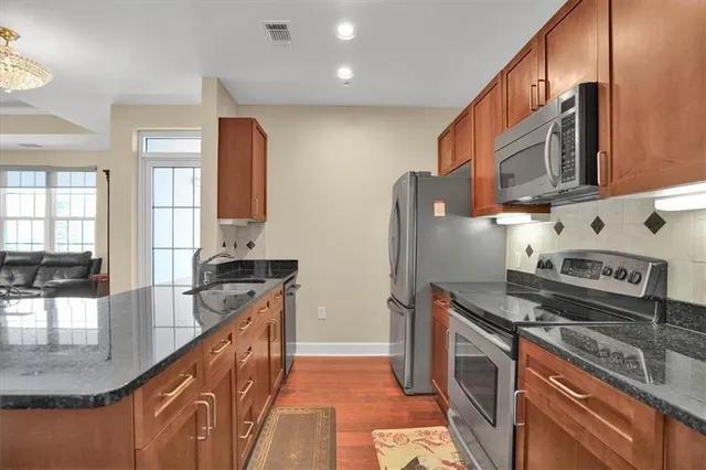 a living room with furniture a wooden floor and a window