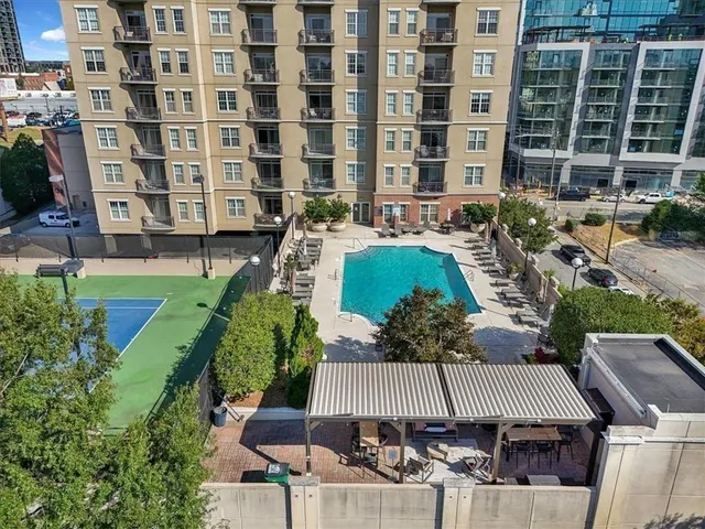 a swimming pool with outdoor seating and yard