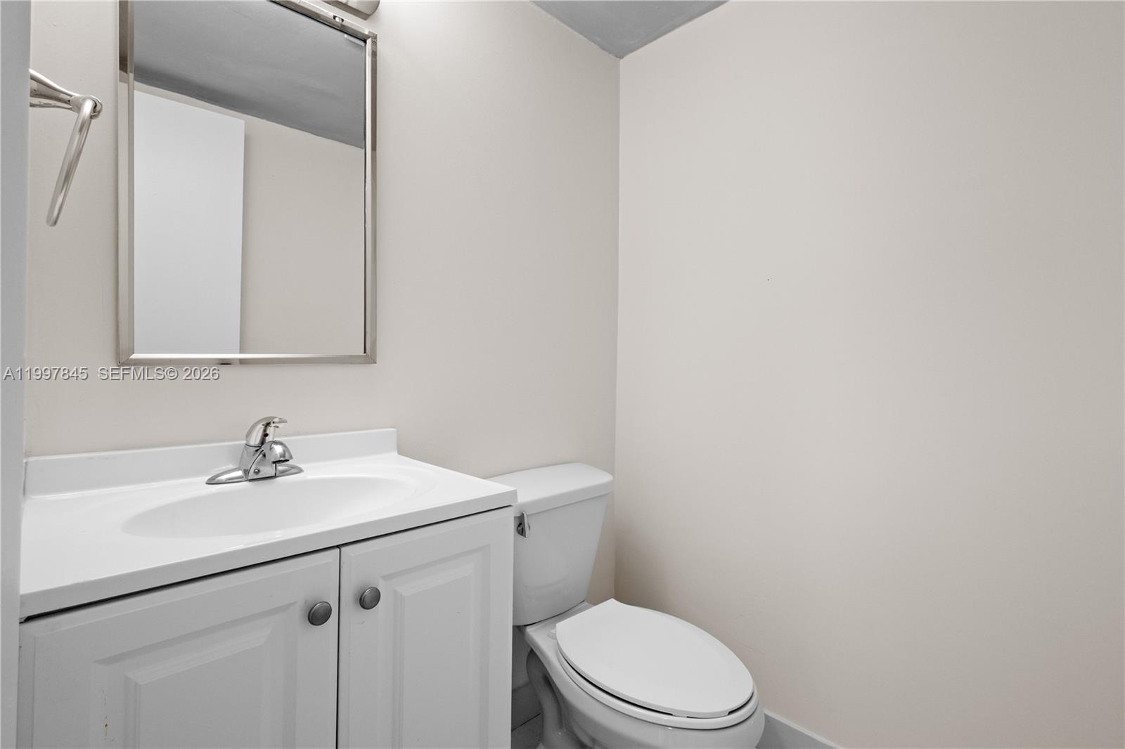 6211 Southwest 138th Court, Unit B Miami, FL 33183 - Photo 11 of 27 a bathroom with a sink mirror vanity and toilet