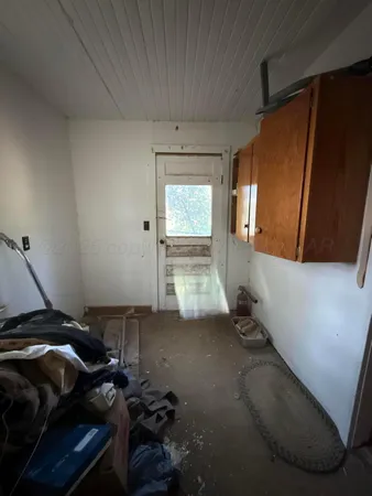 a view of a livingroom with wooden floor and a window