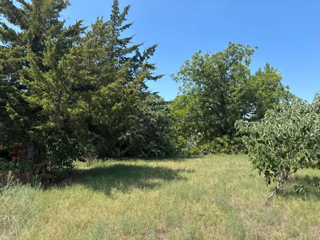 a wooden fence with some trees in the background