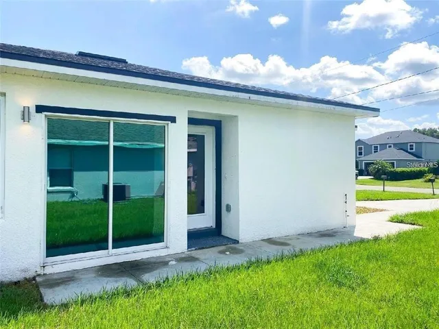 a view of a house with a yard and plants