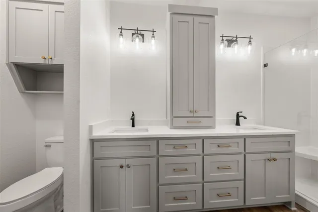 an empty room with wooden floor chandelier fan and windows