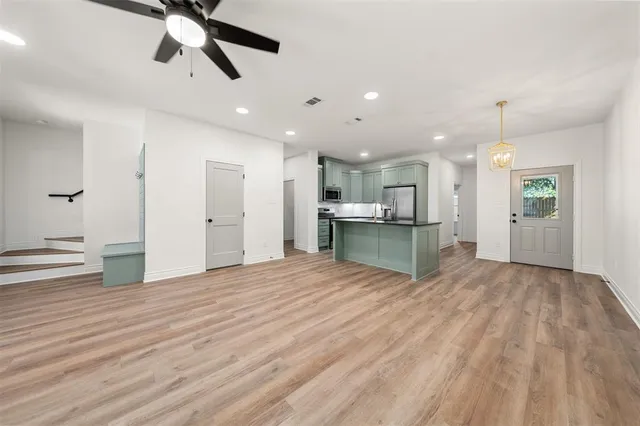 a view of kitchen with cabinets and wooden floor