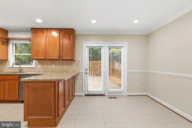 a kitchen with stainless steel appliances granite countertop a refrigerator sink and stove