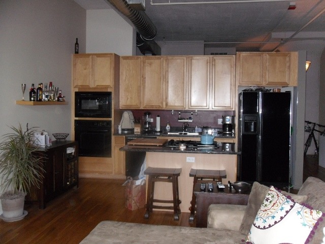 1530 South State Street, Unit 420 Chicago, IL 60605 - Photo 2 of 7 a kitchen with stainless steel appliances granite countertop a refrigerator stove top oven and sink