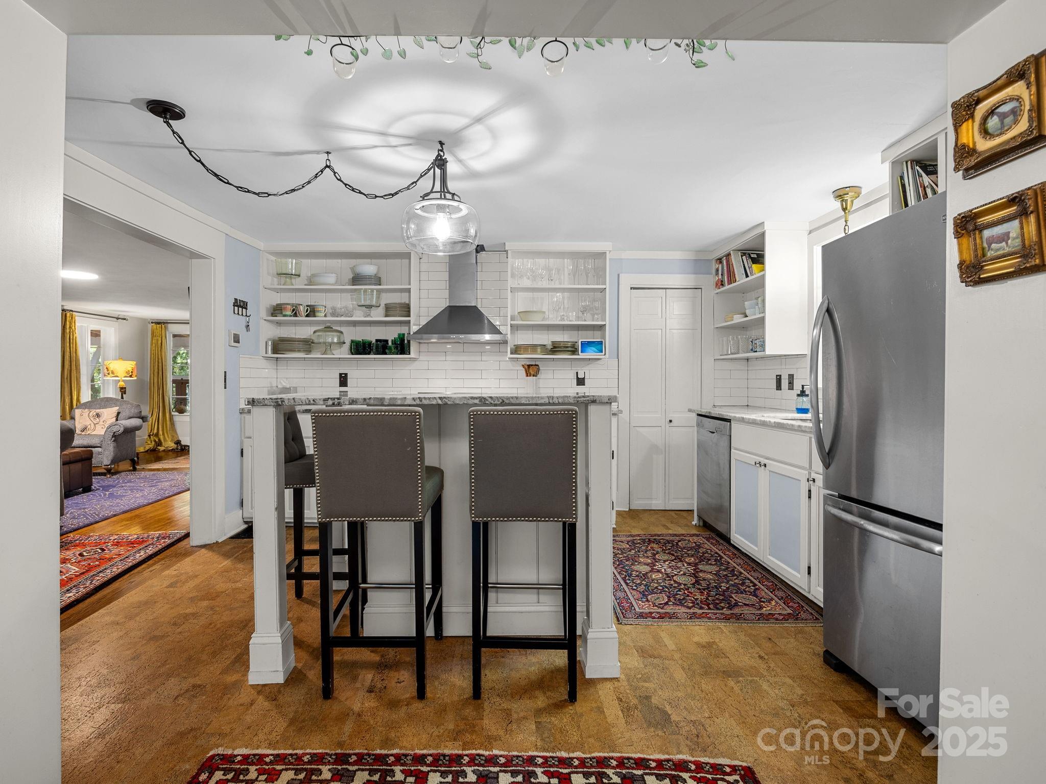 144 Miller Drive Tryon, NC 28782 - Photo 13 of 45 a kitchen with stainless steel appliances granite countertop a table chairs sink and cabinets
