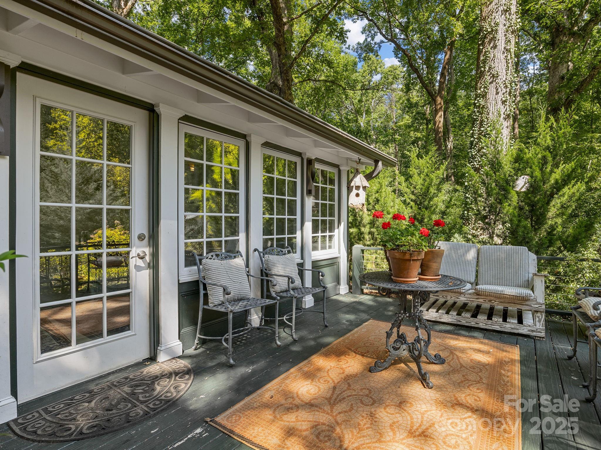 144 Miller Drive Tryon, NC 28782 - Photo 25 of 45 a view of a patio with table and chairs and potted plants