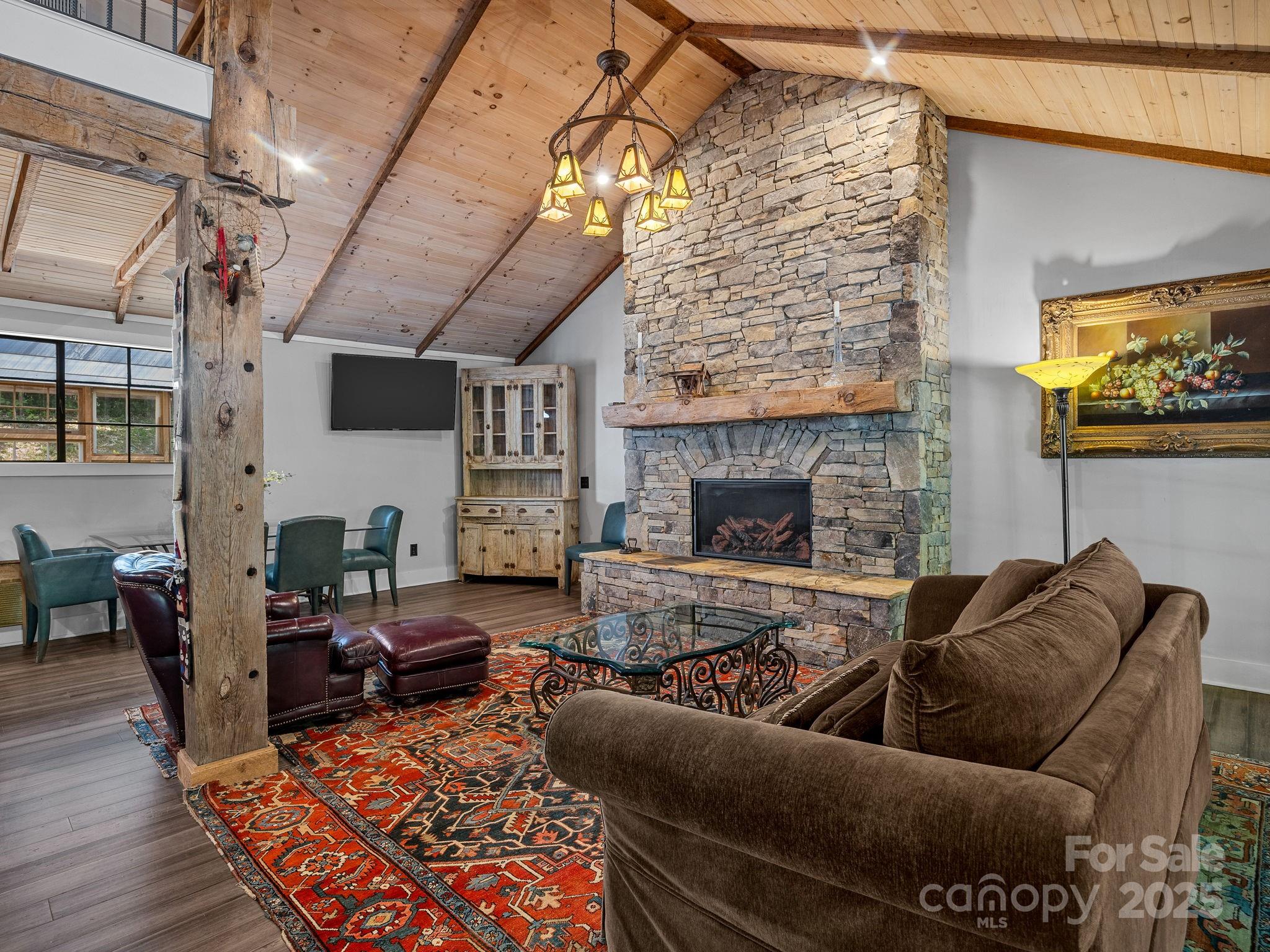 144 Miller Drive Tryon, NC 28782 - Photo 31 of 45 a living room with furniture a flat screen tv and a fireplace