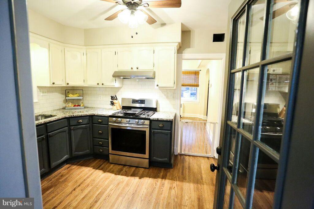 415 Greenwood Road Linthicum, MD 21090 - Photo 11 of 22 a kitchen with stainless steel appliances a stove a refrigerator and cabinets