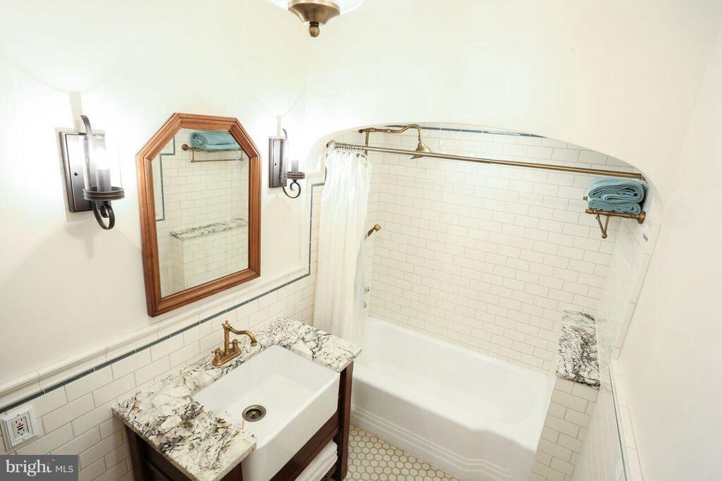 415 Greenwood Road Linthicum, MD 21090 - Photo 16 of 22 a bathroom with a tub sink and mirror