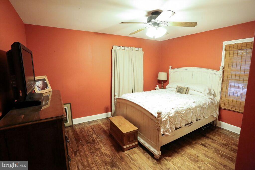 415 Greenwood Road Linthicum, MD 21090 - Photo 22 of 22 a bedroom with a bed and a flat tv screen on the dresser