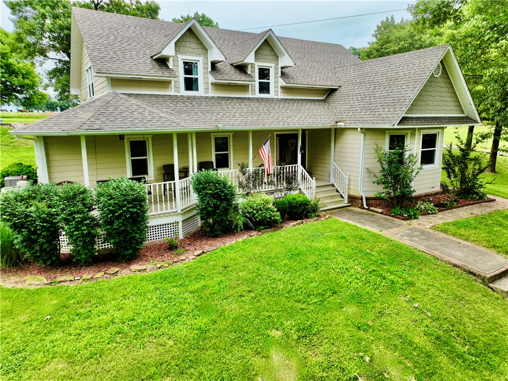 15196 Cincinnati Creek Road Summers, AR 72769 - Photo 2 of 42 Traditional-style residence featuring a covered front porch with white railing, multiple gables, dormer windows, and a concrete walkway